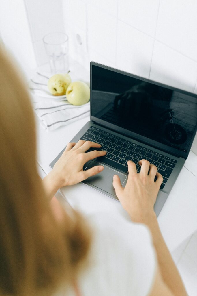 A Person Using Laptop on the Table